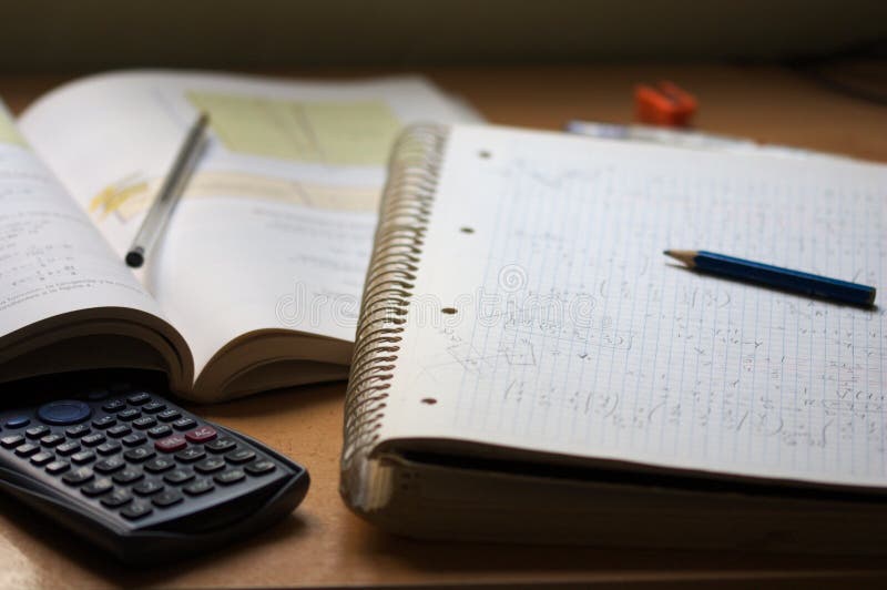 Side view of a book and a notebook with math exercises next to a calculator and a pencil on a student table, students, calculate, homework, studies, paperwork, complicated, handwriting, solution, research, calculus, equations, science, exam, problem, number, symbol, elementary, finance, accessories, office, education, school, study, write, background, university, college, learn, mathematics, knowledge, empty, white, learning, business, studying, equipment, concept, class, desk, closeup. Side view of a book and a notebook with math exercises next to a calculator and a pencil on a student table, students, calculate, homework, studies, paperwork, complicated, handwriting, solution, research, calculus, equations, science, exam, problem, number, symbol, elementary, finance, accessories, office, education, school, study, write, background, university, college, learn, mathematics, knowledge, empty, white, learning, business, studying, equipment, concept, class, desk, closeup