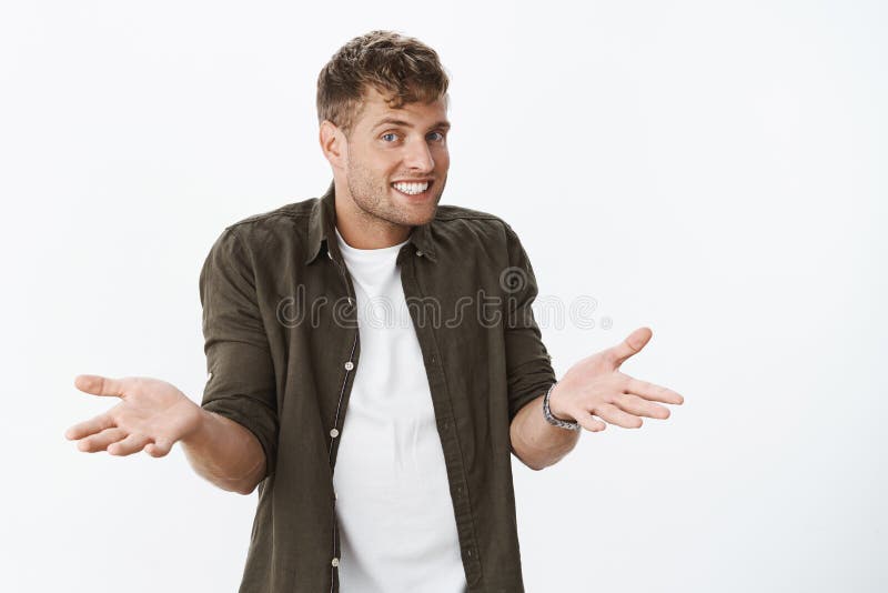 Nothing you can do now. Portrait of careless and unbothered chill handsome male with relaxed smile shrugging confused stock photography Nothing you can do now. Portrait of careless and unbothered chill handsome male with relaxed smile shrugging confused stock photography