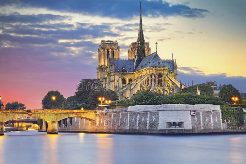 Image of Notre Dame Cathedral at dusk in Paris, France. Image of Notre Dame Cathedral at dusk in Paris, France.