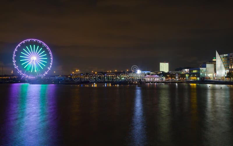 Washington National Harbor, Maryland, USA - August 19, 2018:Potomac River at night with Ferris wheel in National Harbor, Maryland. Washington National Harbor, Maryland, USA - August 19, 2018:Potomac River at night with Ferris wheel in National Harbor, Maryland