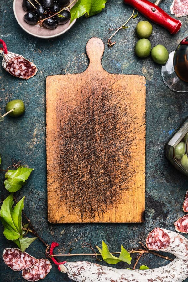 Nourriture et antipasti italiens autour de vieille planche à découper en bois, vue supérieure photographie stock Nourriture et antipasti italiens autour de vieille planche à découper en bois, vue supérieure photographie stock