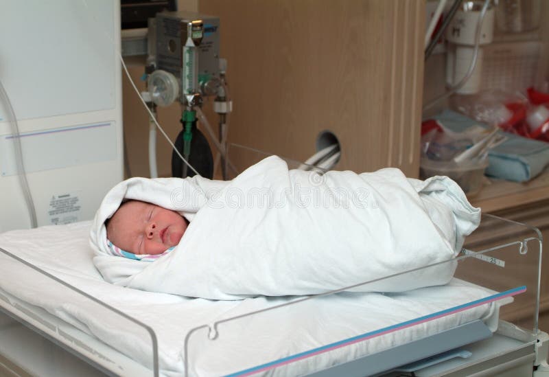 Swaddled newborn in hospital sleeping. Swaddled newborn in hospital sleeping