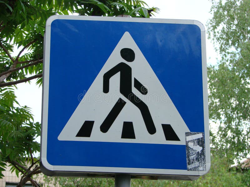 New crosswalk road sign on blue background. New crosswalk road sign on blue background..