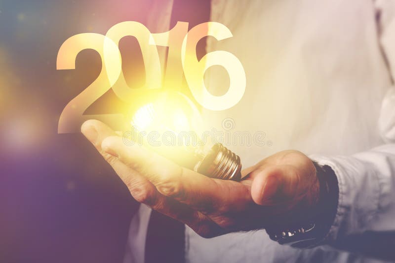 Happy new 2016 business year, businessman with light bulb and number 2016, retro toned image, selective focus. Happy new 2016 business year, businessman with light bulb and number 2016, retro toned image, selective focus.