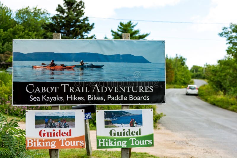 Nova Scotia, Cape Breton Island, Aug 2018: Cabot Trail Adventures sign welcomes tourists, offers guided hiking tours, kayaks and paddle boards for retal for tourists and family. Information sign