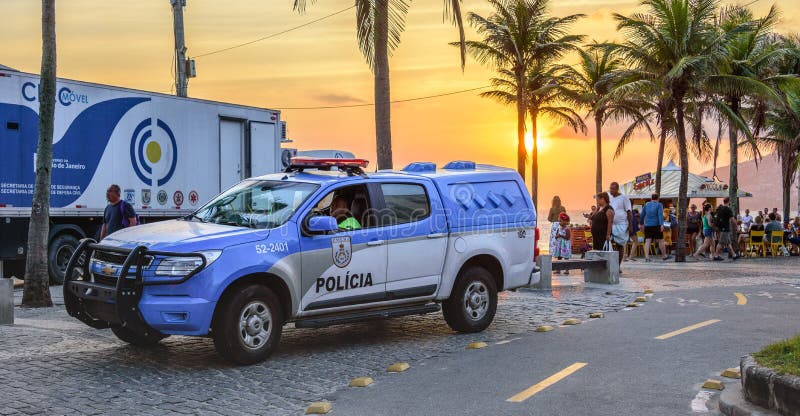 26 November 2016. Police car on the background of beautiful sunset with the orange sun in Ipanema beach, Rio de Janeiro, Brazil
