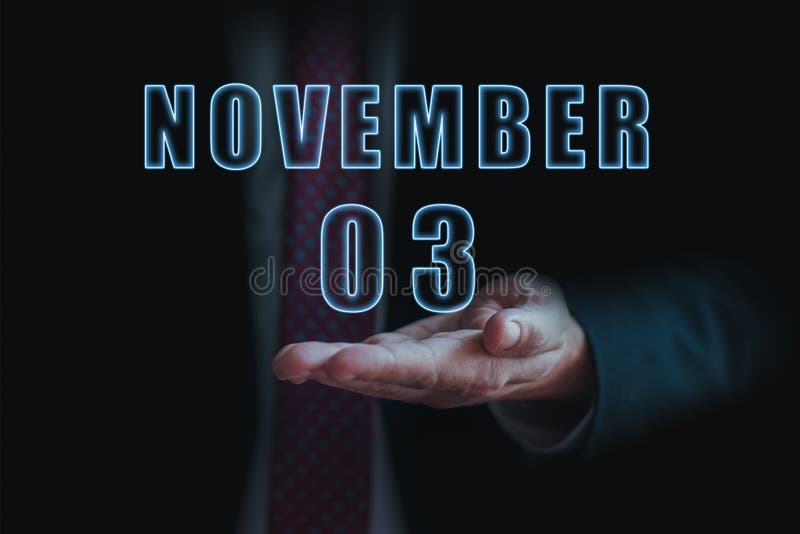 november 3rd. Day 3 of month, announcement of date of business meeting or event. businessman holds the name of the month and day
