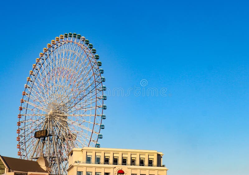 2018 November 03. Yokohama Japan. a giant Cosmo Clock 21 Ferris wheel in evening time with clear blue sky as background. stock photography 2018 November 03. Yokohama Japan. a giant Cosmo Clock 21 Ferris wheel in evening time with clear blue sky as background. stock photography