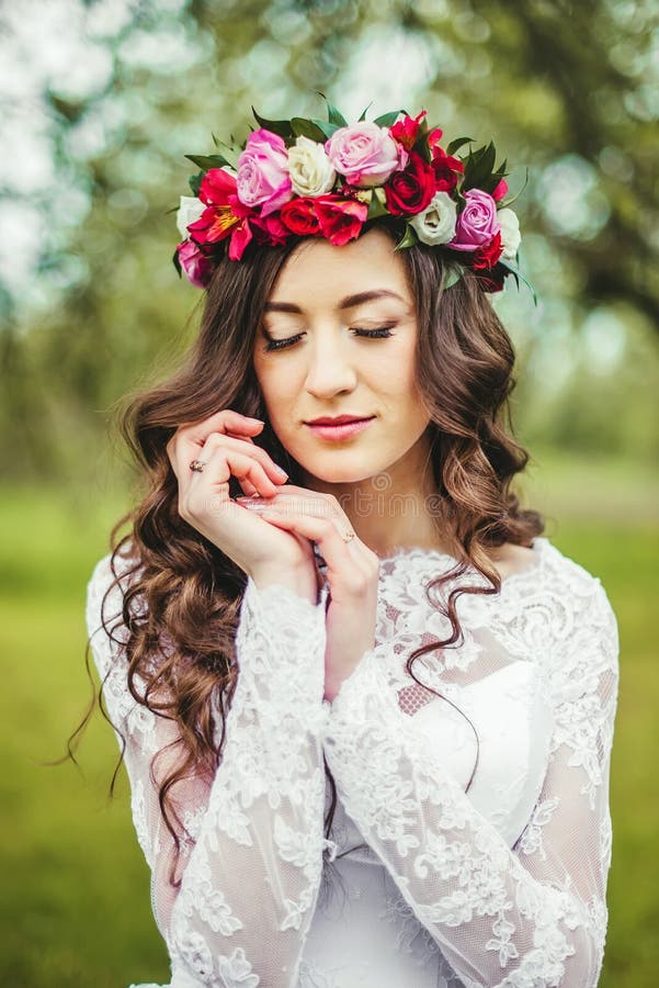 Novia en el vestido blanco en un jardín fotografía de archivo libre de regalías Novia en el vestido blanco en un jardín fotografía de archivo libre de regalías