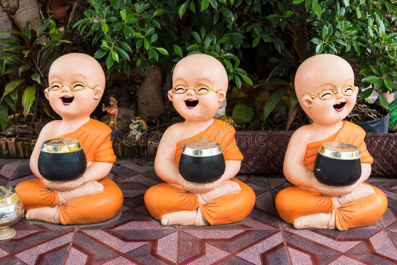 Novices carrying a bowl Statue of novice monks in temple Thailand Buddhist