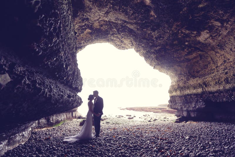 Novio y novia en una cueva fotografía de archivo libre de regalías Novio y novia en una cueva fotografía de archivo libre de regalías