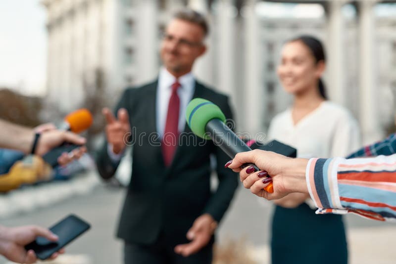 Now you know. Journalists conducting interview of politician. Journalism industry, live streaming concept. Horizontal shot of politician and his assistant royalty free stock photo Now you know. Journalists conducting interview of politician. Journalism industry, live streaming concept. Horizontal shot of politician and his assistant royalty free stock photo