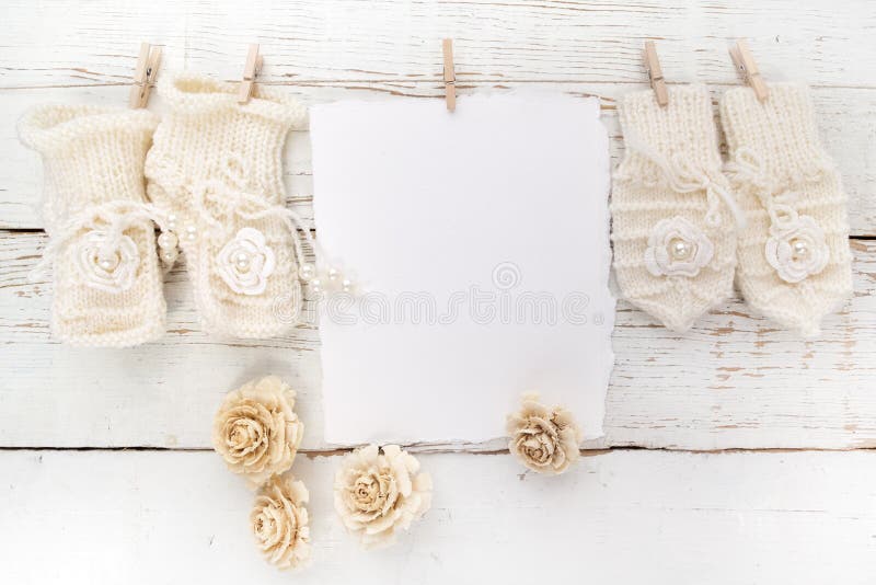 Baby New Born or baptism Greeting Card. Blank card with baby girl shoes and gloves on white wooden background. Baby New Born or baptism Greeting Card. Blank card with baby girl shoes and gloves on white wooden background.