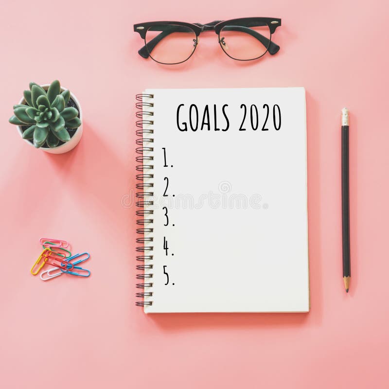 2020 nowy rok pojęcie Cele spisują w notepad, smartphone, materiały na różowym pastelowym kolorze z kopii przestrzenią obrazy stock