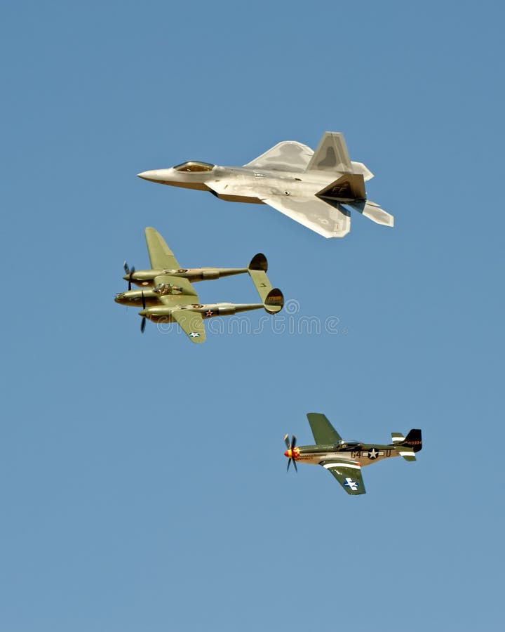 A view of several generations of fighter aircraft in flight at an airshow. A view of several generations of fighter aircraft in flight at an airshow.