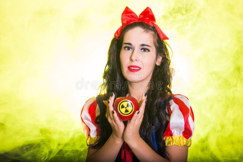 Danger, nuclear and radiation measurement - Girl holds apple with radiation hazard symbol. Nuclear and radiation measurement - Girl holds apple with radiation stock images Danger, nuclear and radiation measurement - Girl holds apple with radiation hazard symbol. Nuclear and radiation measurement - Girl holds apple with radiation stock images