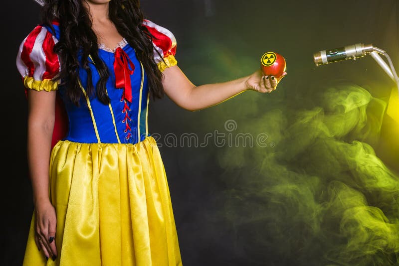 Danger, nuclear and radiation measurement - Girl holds apple with radiation hazard symbol. Nuclear and radiation measurement - Girl holds apple with radiation stock images Danger, nuclear and radiation measurement - Girl holds apple with radiation hazard symbol. Nuclear and radiation measurement - Girl holds apple with radiation stock images