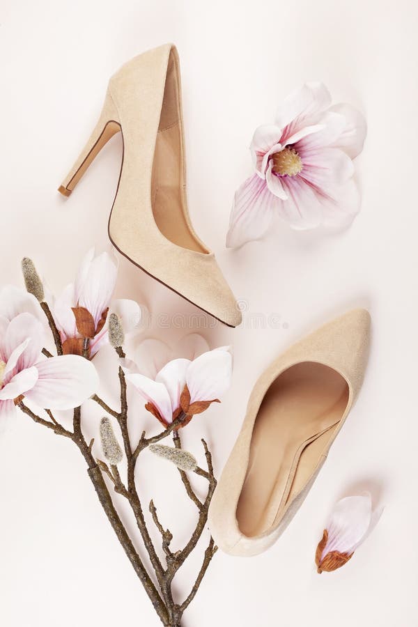 Nude colored high heels shoes and magnolia flowers