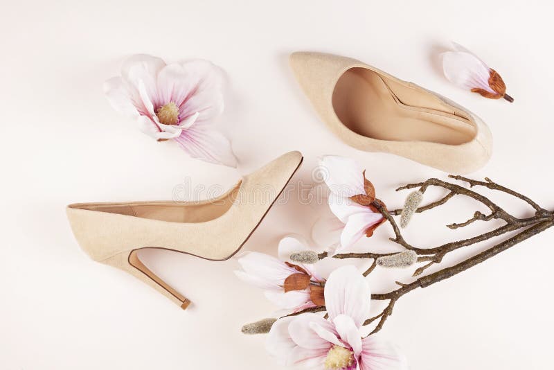 Nude colored high heels shoes and magnolia flowers