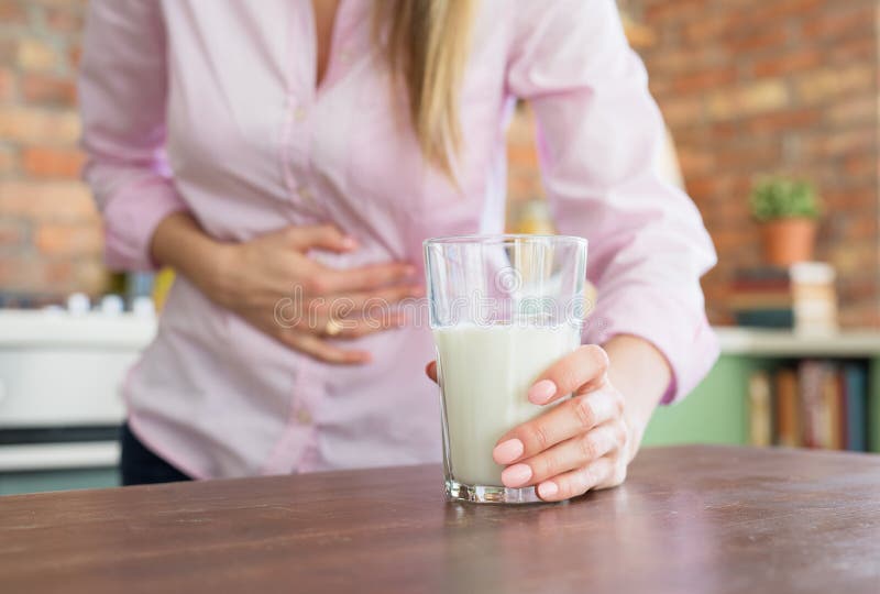 Woman feeling sick by drinking milk. Woman feeling sick by drinking milk