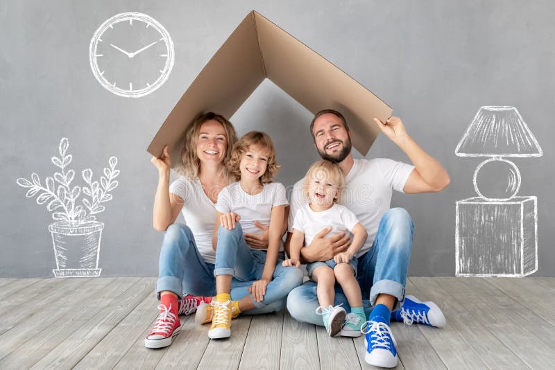 Happy family with two kids playing into new home. Father, mother and children having fun together. Moving house day and real estate concept. Happy family with two kids playing into new home. Father, mother and children having fun together. Moving house day and real estate concept