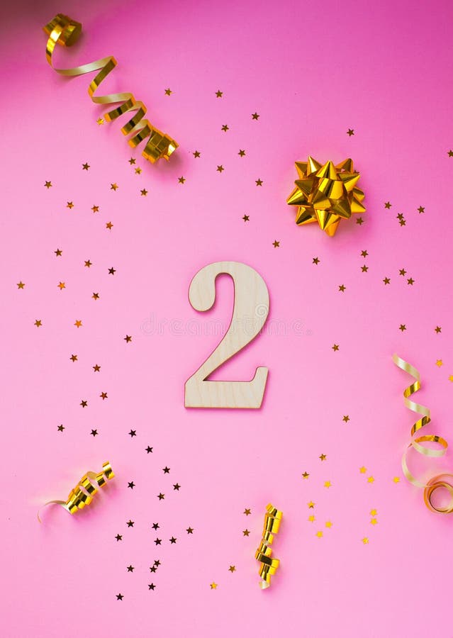 Number 2 celebration on star and glitter pink background