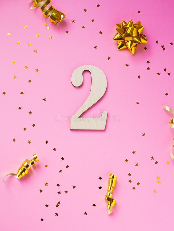 Number 2 celebration on star and glitter pink background