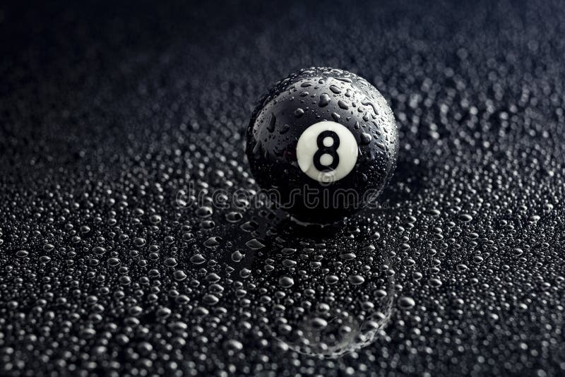 Number eight billiard ball with water drops on a black background