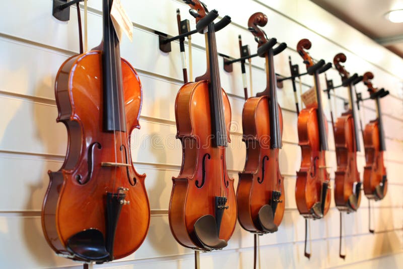 A number of violins hanging on the wall royalty free stock photo A number of violins hanging on the wall royalty free stock photo