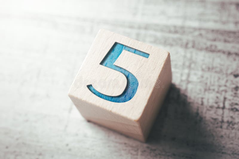 Number 5 On A Wooden Block On A Table royalty free stock images