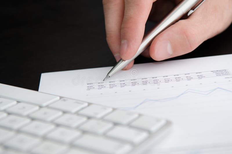 Numbers in Business Report with Hand Holding Pen. Stock Photo - Image ...