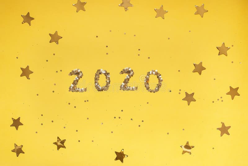 2020 numbers from small confetti with shining stars . Festive background. New Year. Top view.