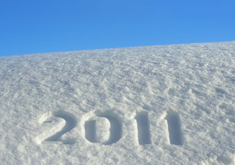 Number 2011, written on snowdrift and blue sky, New Year's background. Number 2011, written on snowdrift and blue sky, New Year's background