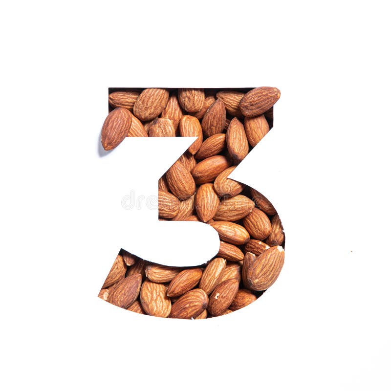 Number three made of almonds and paper cut in shape of third numeral isolated on white. Typeface of nuts. High quality photo. Number three made of almonds and paper cut in shape of third numeral isolated on white. Typeface of nuts. High quality photo