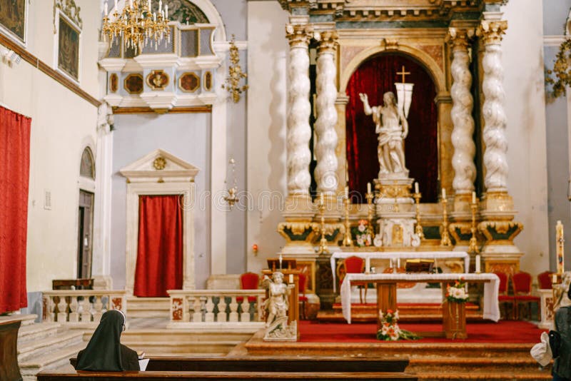 Interior of Church of the Holy Annunciation in the old town of Dubrovnik, Croatia. A nun on a bench sits in front of