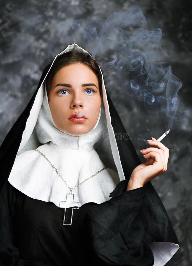 Portrait of a smoking young nun stock photography.