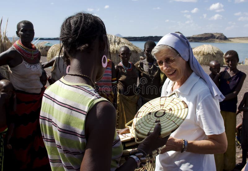 Nuns of Christian church buy handicrafts african tribe. LAKE TURKANA, KENYA-JAN 12:Nuns of Christian church buy handicrafts tribe El molo near lake Turkana royalty free stock photos Nuns of Christian church buy handicrafts african tribe. LAKE TURKANA, KENYA-JAN 12:Nuns of Christian church buy handicrafts tribe El molo near lake Turkana royalty free stock photos