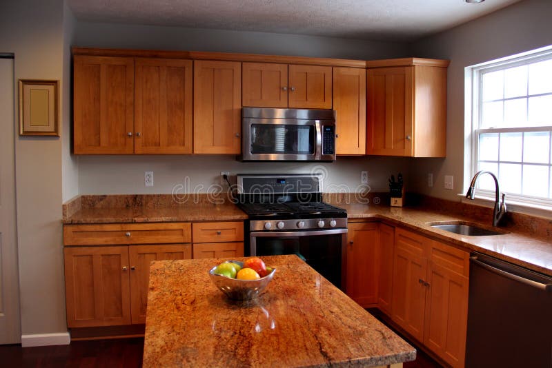 New kitchen with wooden cabinets and island. New kitchen with wooden cabinets and island