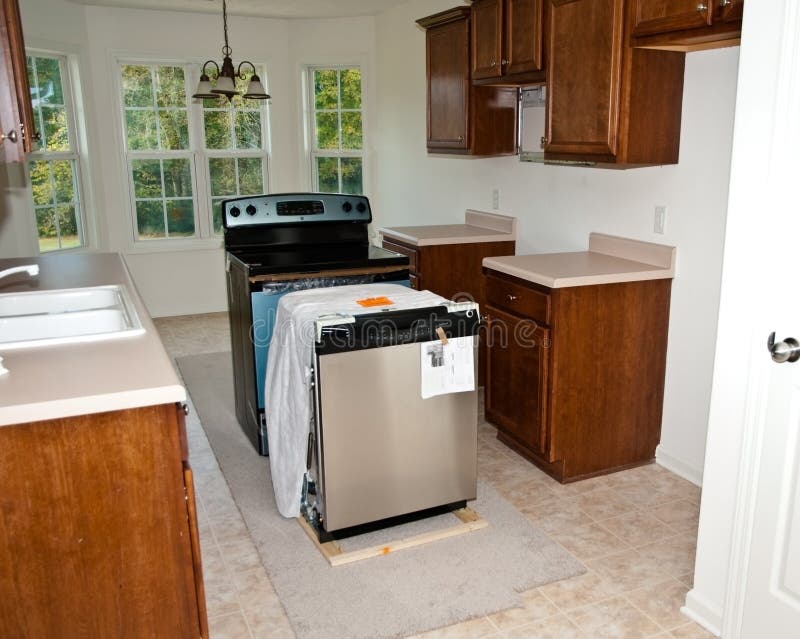 New appliances in the kitchen ready to be installed to upgrade the space. New appliances in the kitchen ready to be installed to upgrade the space.