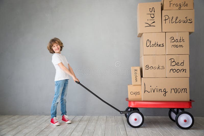 Happy child playing into new home. Kid having fun indoor. Moving house day and express delivery concept. Happy child playing into new home. Kid having fun indoor. Moving house day and express delivery concept