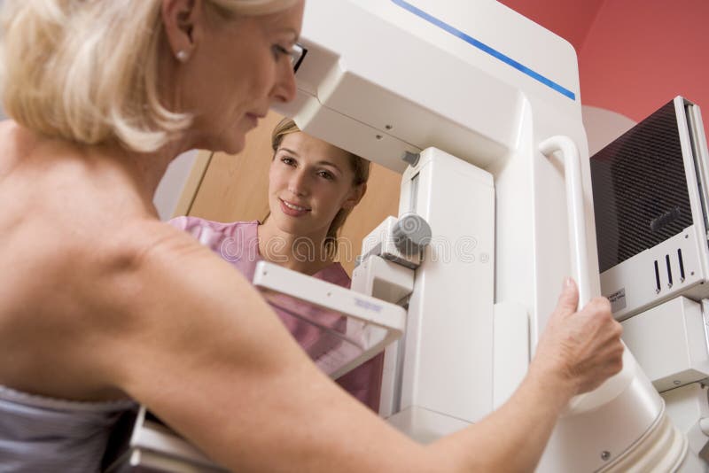 Nurse Assisting Patient Undergoing Mammogram