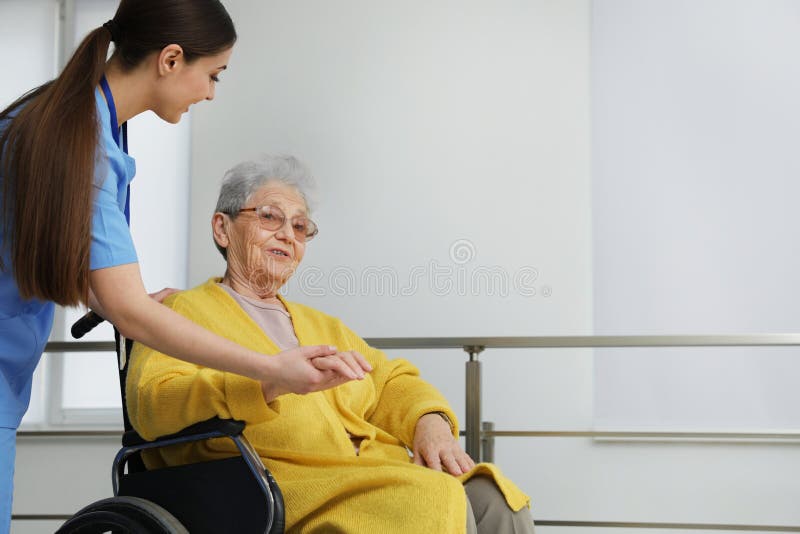 Nurse assisting senior women in wheelchair at hospital. Nurse assisting senior women in wheelchair at hospital