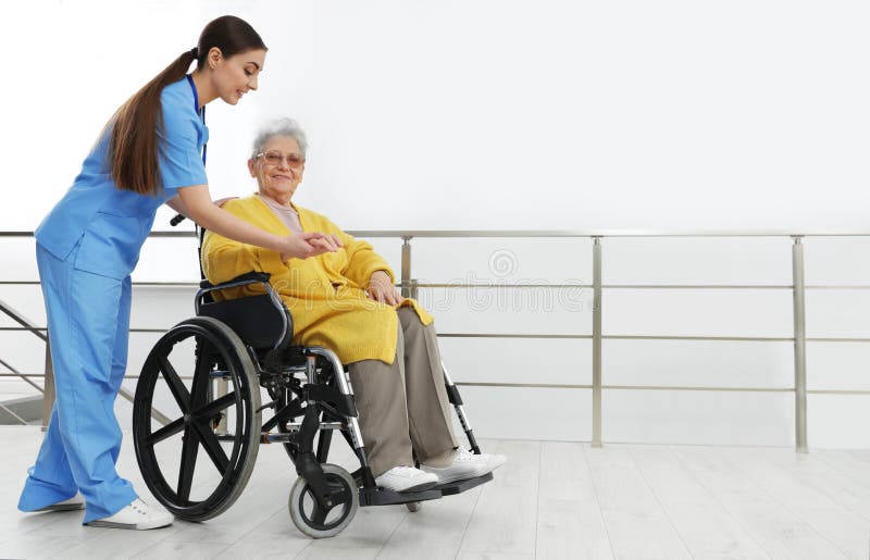 Nurse assisting senior women in wheelchair at hospital. Nurse assisting senior women in wheelchair at hospital