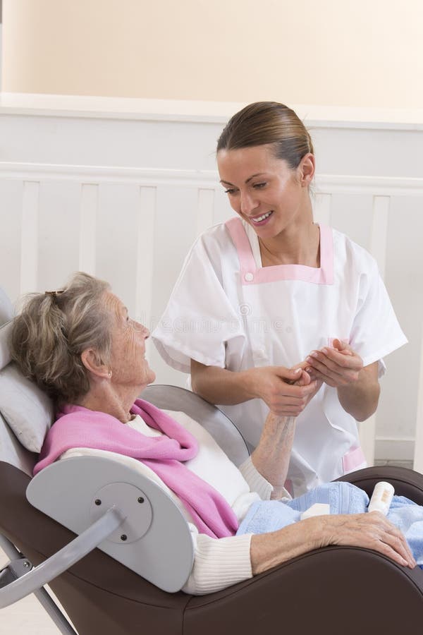 Nurse or caregiver assists an elderly women with hygiene measures at home. Nurse or caregiver assists an elderly women with hygiene measures at home