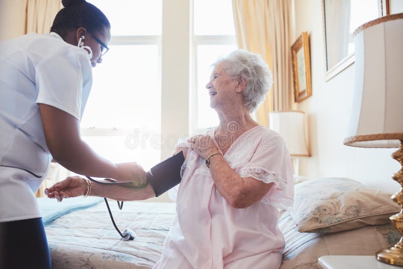 Nurse Checking Blood Pressure Of A Senior Woman Stock Image Image Of