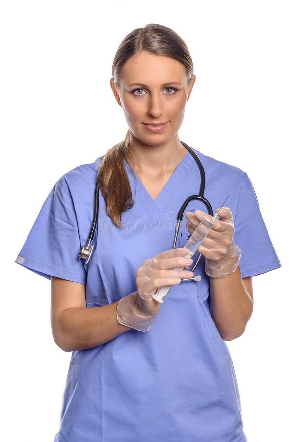 Serious attractive female nurse or doctor holding a large hypodermic syring...
