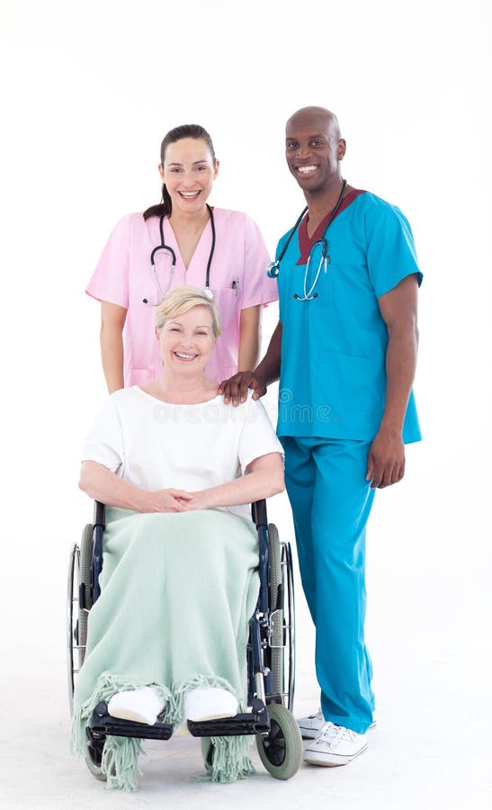 Nurse and doctor looking after a senior patient in a wheel chair. Nurse and doctor looking after a senior patient in a wheel chair