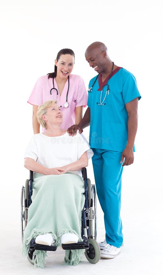 Nurse and doctor taking care of a senior patient in a wheel chair. Nurse and doctor taking care of a senior patient in a wheel chair