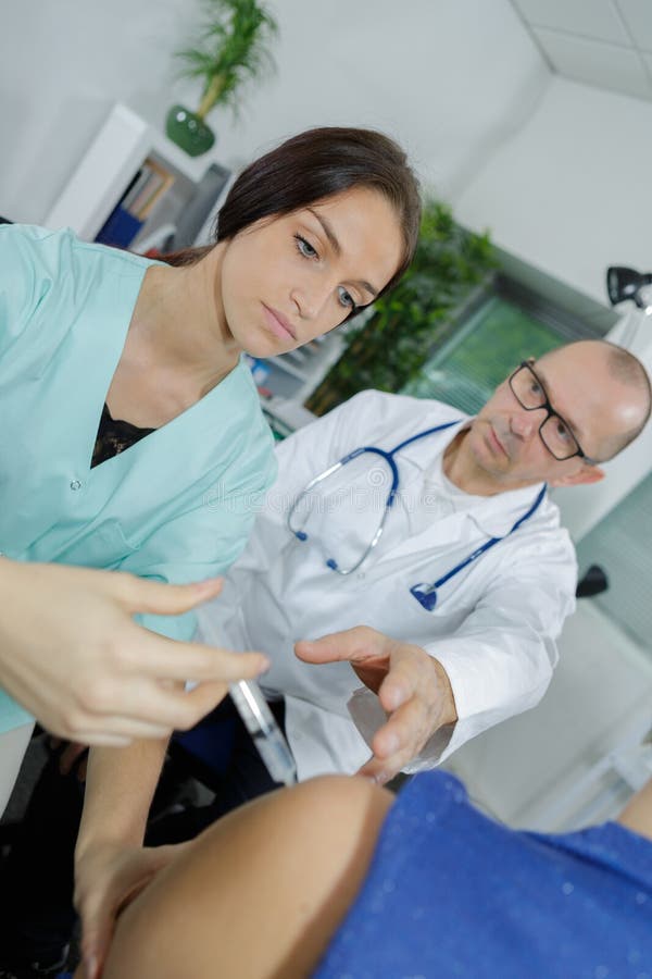 Nurse doing an injection stock photo. Image of liquid 120354920