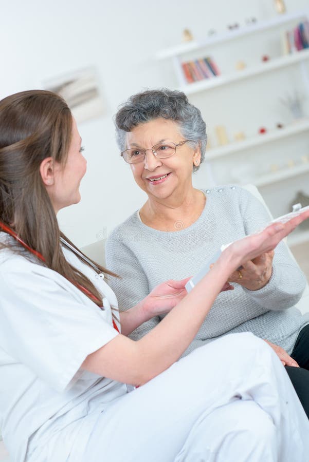Nurse in the house stock image. Image of insurance, professional